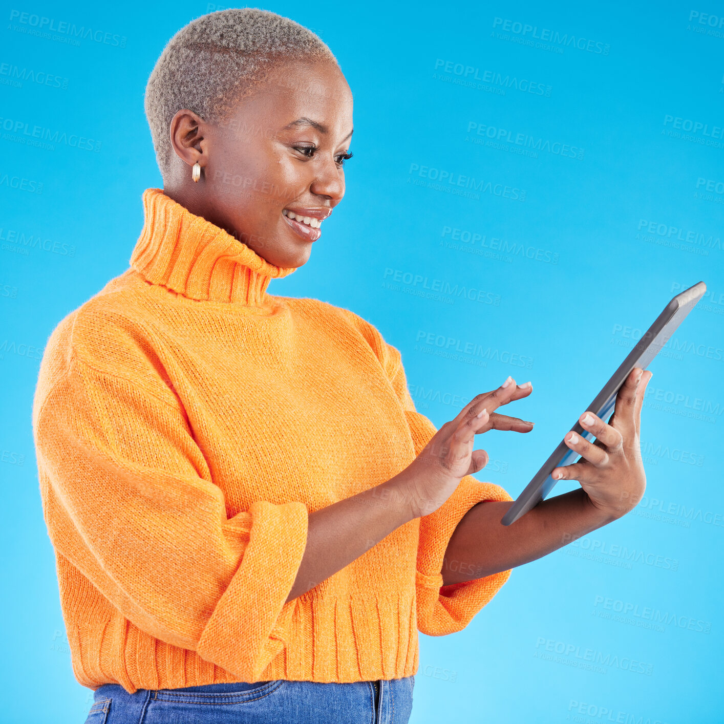 Buy stock photo Typing, happy or black woman in studio with tablet to search social media on internet or blue background. Networking, email chat or entrepreneur with technology for online review, news or feedback