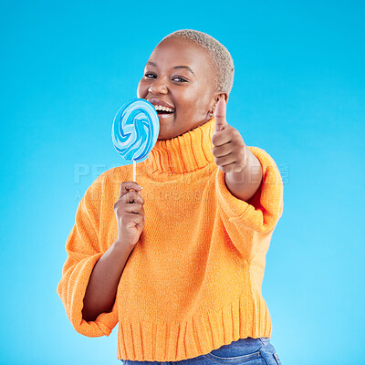 Buy stock photo Thumbs up, lollipop and black woman in portrait with candy in studio isolated on a blue background. African person, happy face and sweets, dessert and sugar food with like hand sign for excellence