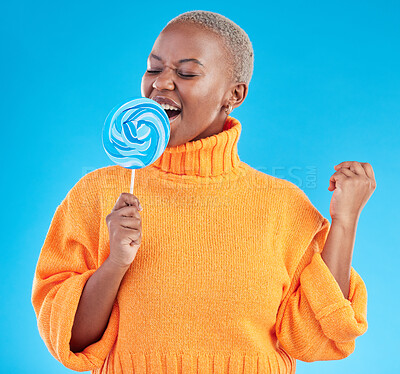Buy stock photo Singing, lollipop and a woman with candy in studio for sweets, rainbow and creative advertising. Happy black female person isolated on a blue background with sugar, freedom and happiness or color
