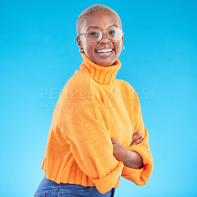 Buy stock photo Portrait, happy and black woman with glasses, arms crossed and studio isolated on a blue background. Face, confident nerd and smile for fashion, style and person from South Africa in casual clothes