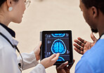 Tablet, cancer or x ray of the brain with a doctor and nurse talking in a hospital for diagnosis closeup. Medical, technology and healthcare with a professional medicine team in a clinic for review