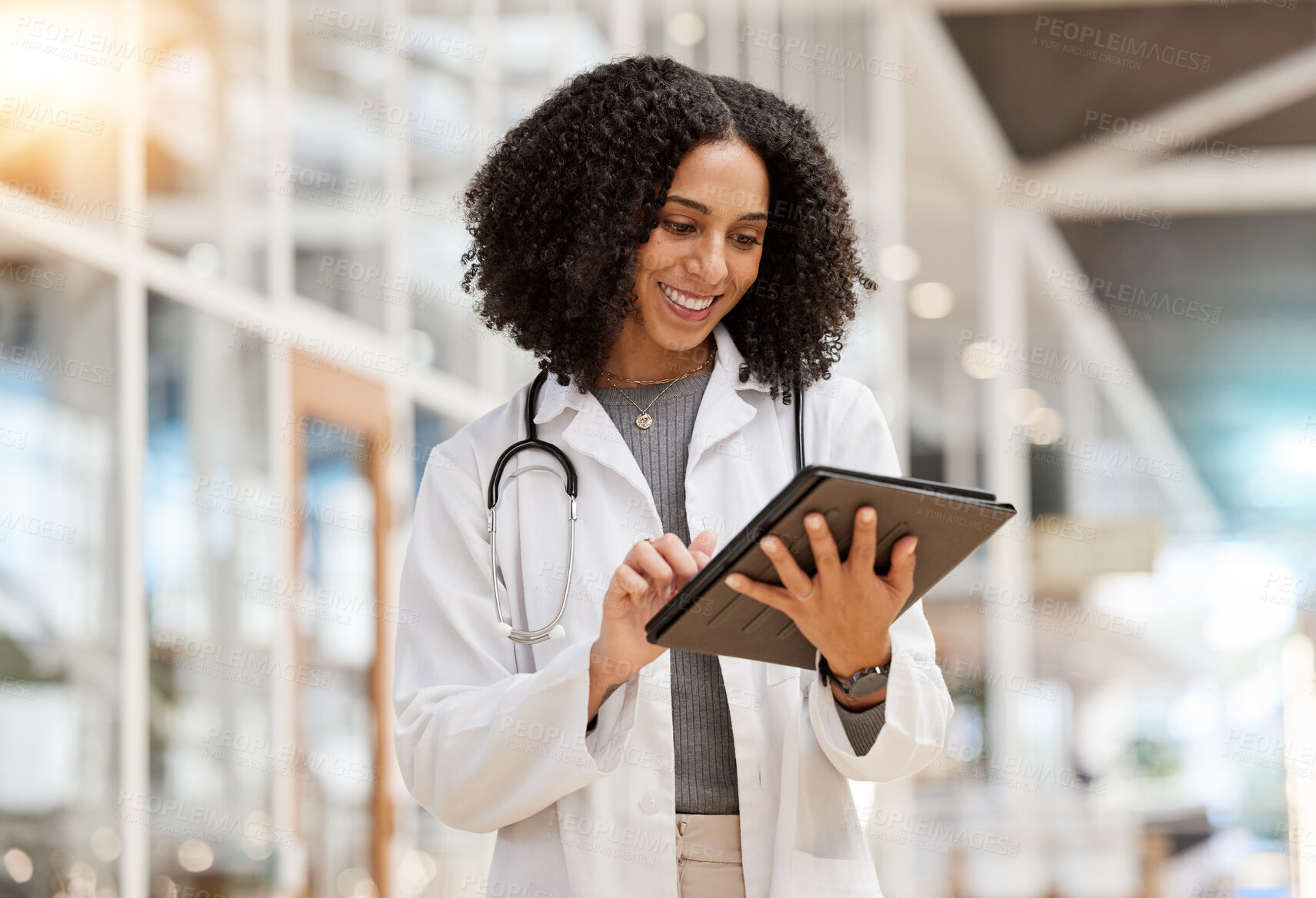 Buy stock photo Smile, doctor and woman with tablet for research, telehealth or healthcare in hospital. Technology, happy and African medical professional on wellness web app, online consultation and reading email