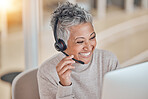 Computer, smile and a senior woman in a call center for customer service, support or assistance online. Contact, headset and a happy female consultant working at a desk in her professional crm office