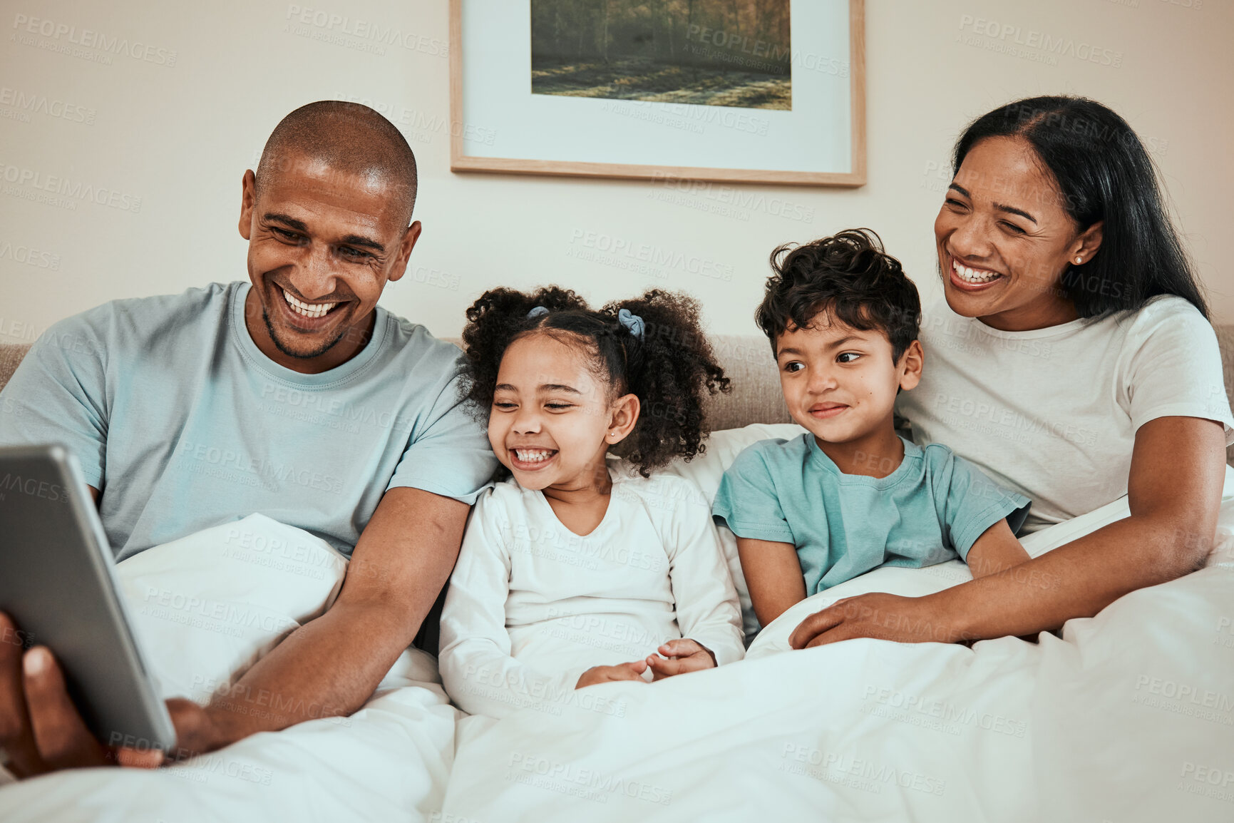 Buy stock photo Parents watching a movie on a tablet with their kids in the bed to relax, rest and bond. Happy, smile and children streaming show or video on social media on digital technology with mother and father