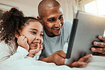 Father watching a movie on a tablet with his child in bed to relax, rest and bond together. Happy, smile and young dad streaming show or video on social media on digital technology with kid at home.
