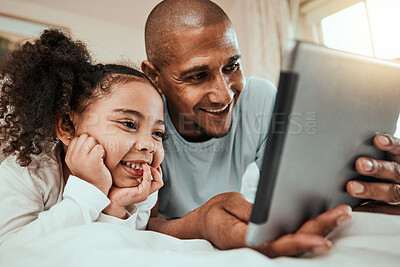 Buy stock photo Father watching a movie on a tablet with his child in bed to relax, rest and bond together. Happy, smile and young dad streaming show or video on social media on digital technology with kid at home.