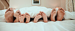 Sleeping, feet and family in bed relax, peaceful and enjoying. a nap in their home together. Foot, sleep and children resting with in parents in a bedroom with love, safety and or vacation freedom