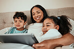 Mother watching a movie on a tablet with her children in the bed to relax, rest and bond. Happy, smile and young mom streaming a show or video on social media on digital technology with kids at home.