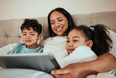 Buy stock photo Mother watching a movie on a tablet with her children in the bed to relax, rest and bond. Happy, smile and young mom streaming a show or video on social media on digital technology with kids at home.