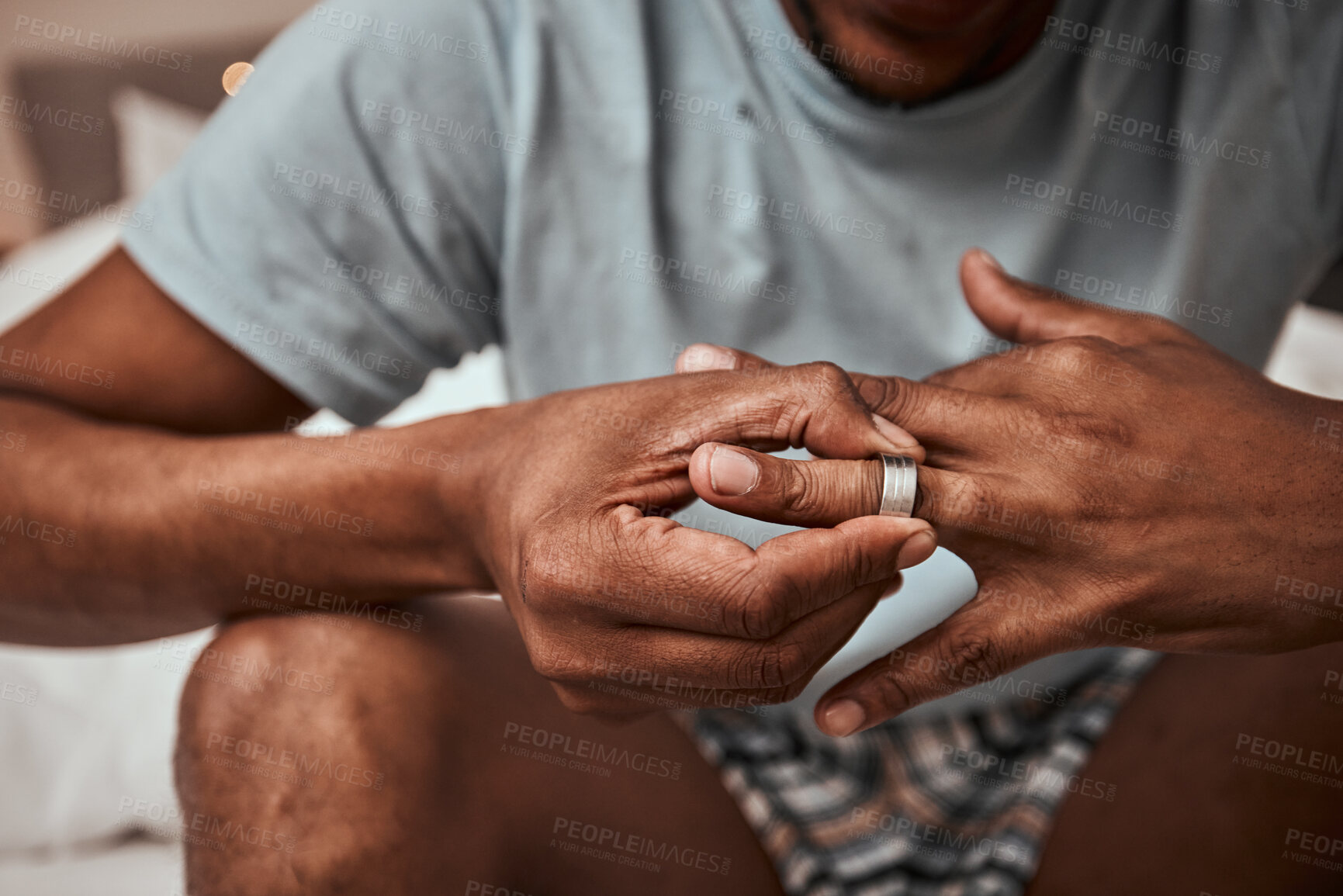 Buy stock photo Divorce, breakup and wedding ring with hands of person in bedroom for fight, conflict and sad. Jewelry, doubt and affair with closeup of man and engagement band at home for angry, problem and loss