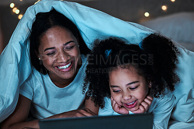 Buy stock photo Mom, child and tablet with blanket in bedroom at night to play games, social media and reading ebook. Happy mother, girl and kid relax with digital technology, watching cartoon or movies in dark fort