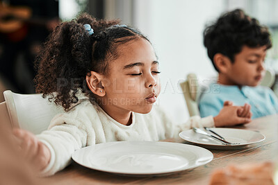 Buy stock photo Kids, holding hands and praying at dinner, home and faith for gratitude, solidarity and mindfulness for food. Children, prayer and religion for event, lunch or brunch with eyes closed in family house