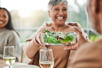 Senior woman, salad and family dinner at thanksgiving celebration at home. Food, elderly female person and eating at a table with a smile from hosting, lunch and social gathering on holiday in house