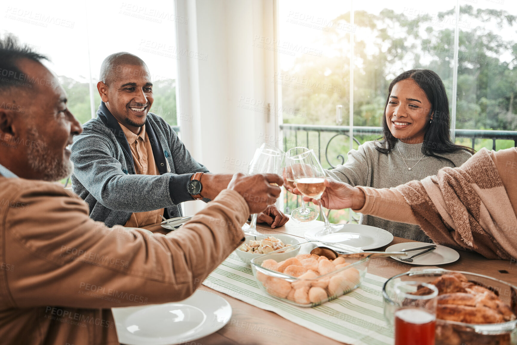 Buy stock photo Wine, food and toast with family at dining table for party, celebration and holiday. Lunch, happy and success with  group of people and cheers with glass at home for event, support or dinner together