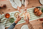 Wine, food and toast with hands of family at dining table for party, celebration and holiday from above. Lunch, cheers and success with closeup of people and at home for event, support and dinner