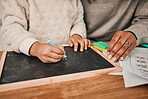 Hands, writing and mom with child on home, table for remote learning, education or drawing on chalkboard or desk in house. Helping, teaching and creative kid with chalk and support from parent