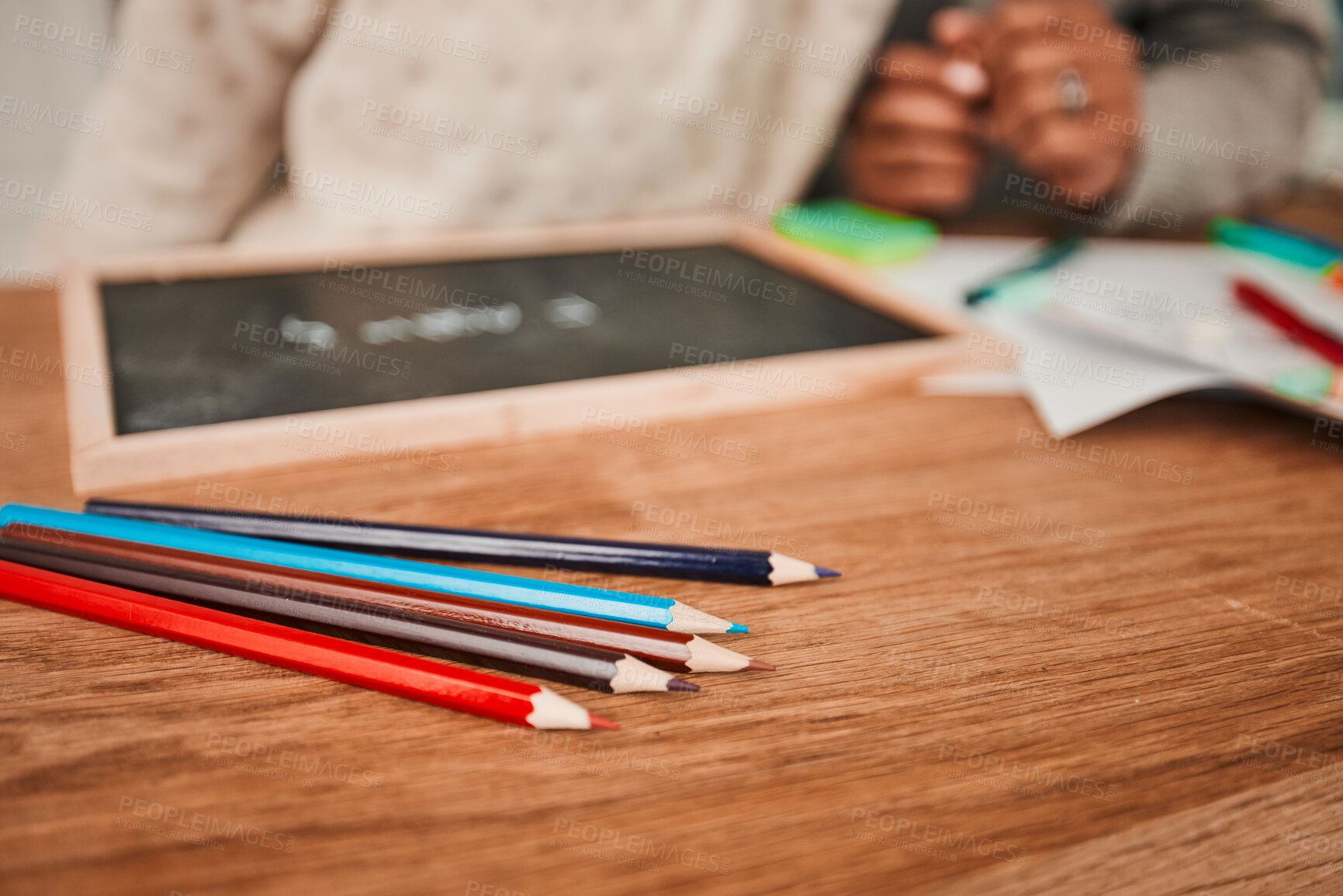 Buy stock photo Hands, helping and child with pencils on table for remote learning, education or writing on board, paper or desk in house. Closeup, drawing and creative kid working on art with parent in home