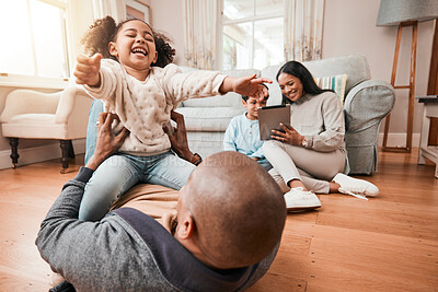 Buy stock photo Happy, relax and playing with family on floor of living room for funny, support and freedom. Smile, happiness and youth with father and tickling child at home for care, trust and bonding together