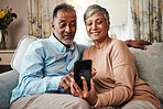 Senior couple, phone and reading on home sofa with internet connection, network and love. Mature man and woman relax together on a couch with smartphone for streaming and online news or social media
