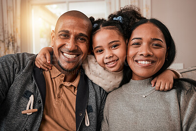Buy stock photo Happy, smile and portrait of a family in the living room hugging with love, care and comfort at home. Happiness, excited and girl child holding her mother and father in the lounge of their house.