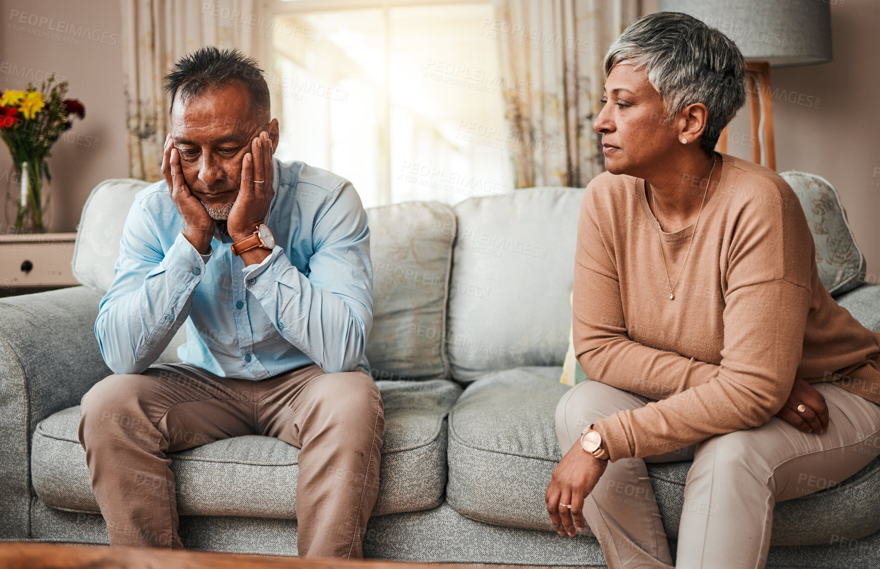 Buy stock photo Angry, senior couple and fight on sofa, divorce and conflict with a breakup, depression and stress. Sad, old woman and elderly man with mental health, cheating and separation with crisis at home
