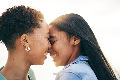 Buy stock photo Lesbian couple, love and intimate outdoor at sunset, bonding and romance on date together. Happy, gay women and forehead touch for care, commitment and loyalty, trust and support for lgbtq people