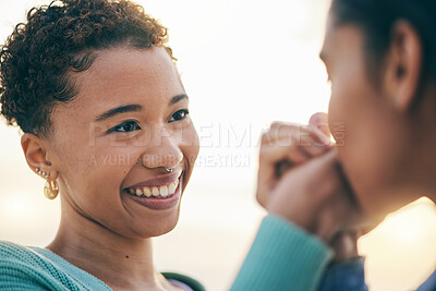 Buy stock photo Lesbian, holding hands or gay couple kiss with love or pride in LGBTQ community with smile or support. Friends, women or happy people in nature on a romantic date or commitment on holiday vacation