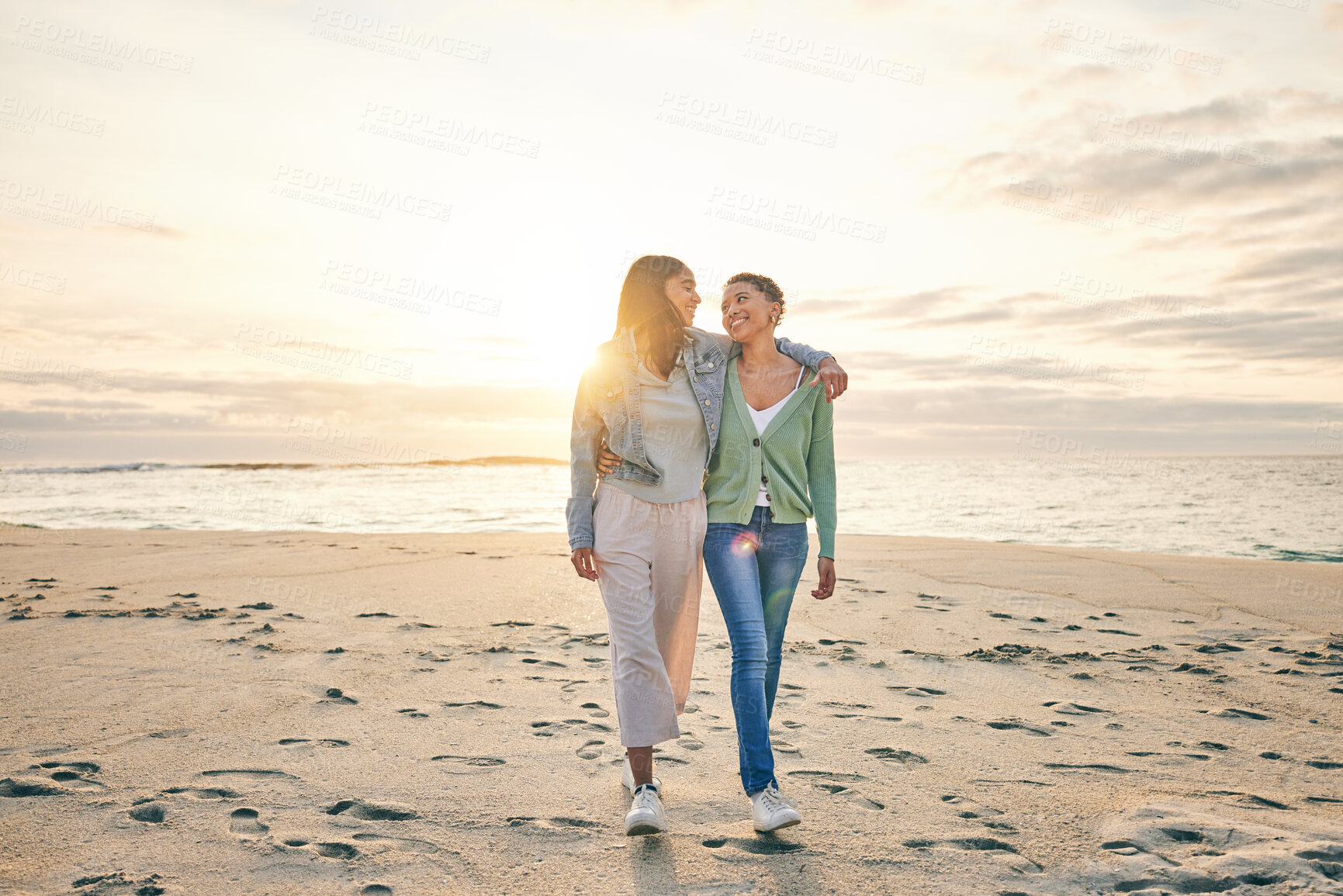Buy stock photo Love, beach and sunset, lesbian couple walking together on sand mockup, sunset holiday and hug on date. Lgbt women, bonding and relax on ocean vacation with romance, pride and happy nature travel.