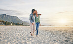 Love, beach and lesbian couple hug while walking together on sand, sunset holiday adventure or date. Lgbt women, bonding and relax on ocean vacation with romance, pride and happy travel in nature.