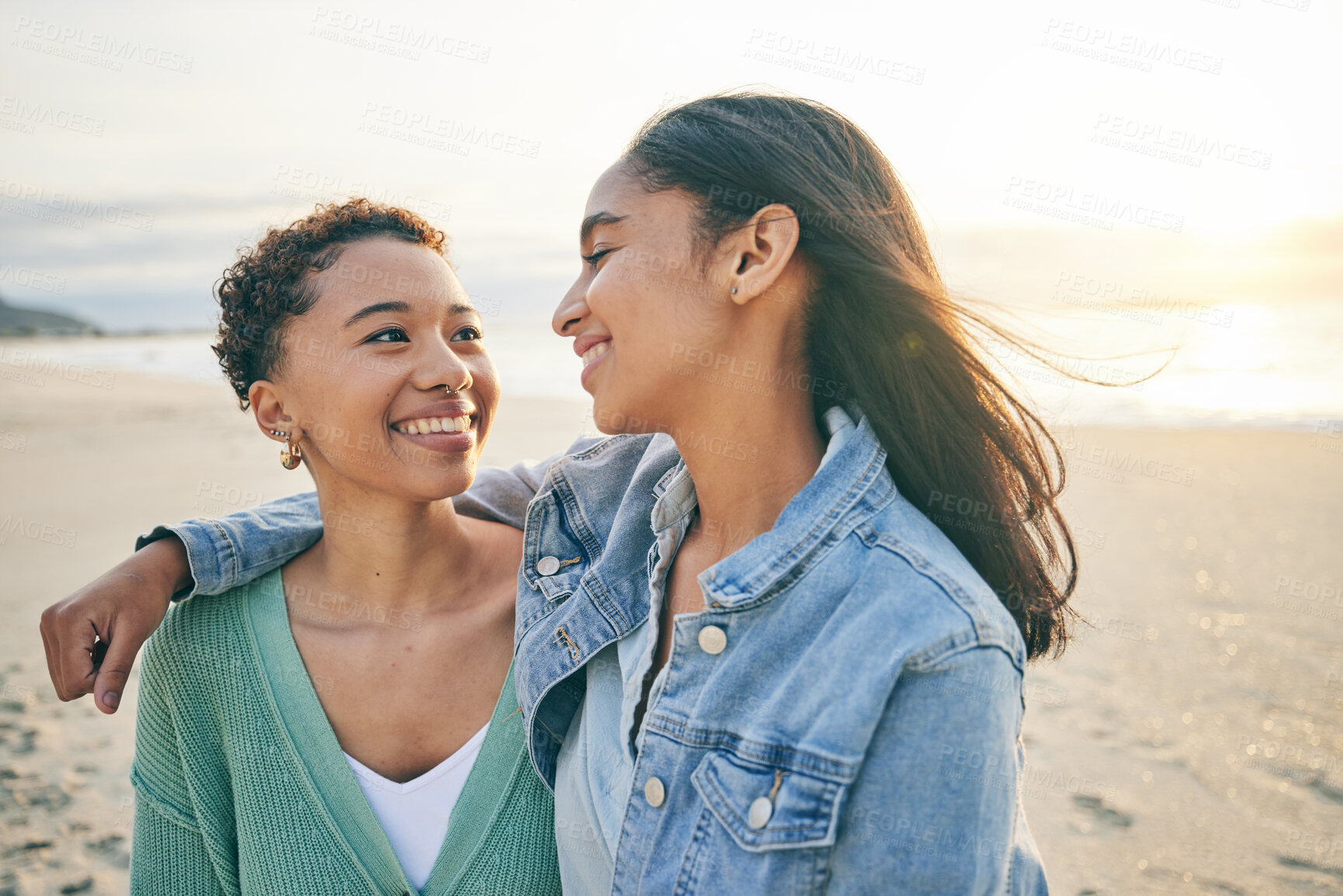 Buy stock photo Beach, hug and queer couple with love, lesbian and happiness with marriage, romance and relationship. Lgbtq, female people or women on a seaside holiday, vacation and quality time with sunset and joy