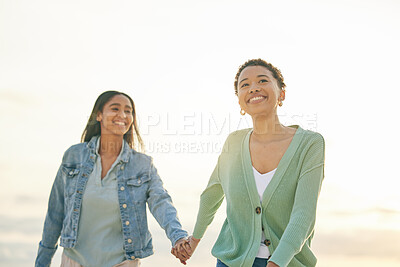 Buy stock photo Love, beach and smile, lesbian couple holding hands and walking together on sunset holiday adventure. Lgbt women, bonding and relax on ocean vacation with romantic date, pride and happy nature travel