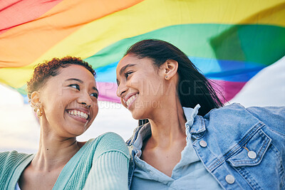 Buy stock photo Lesbian women, couple and outdoor with pride flag, smile or wind with wave, lgbtq inclusion and equality. African girl, fabric or cloth for human rights, sexuality and happy with rainbow on vacation