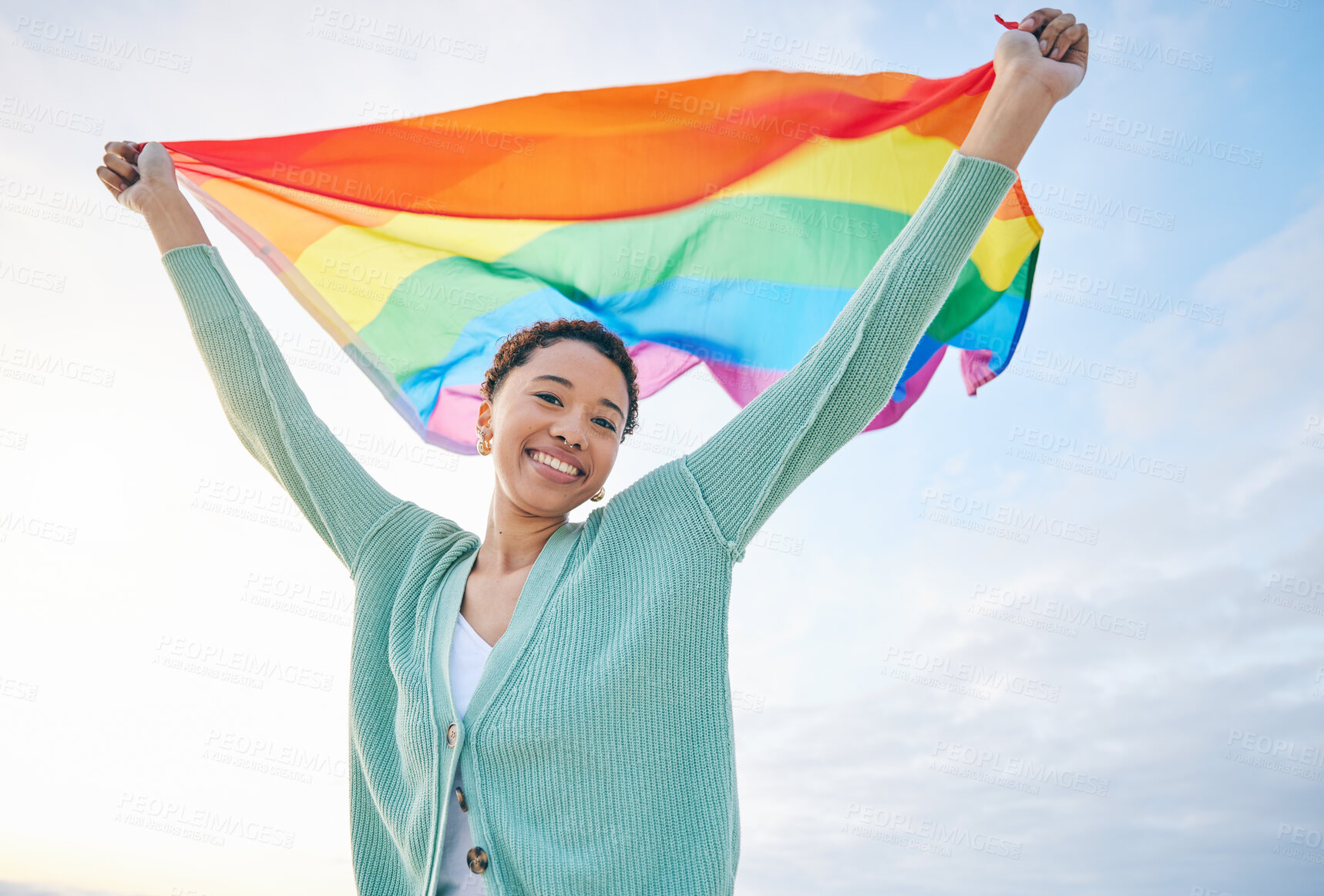 Buy stock photo Woman, outdoor and rainbow pride flag in portrait with smile, wind and wave for lgbtq, inclusion and equality. African girl, fabric or cloth for human rights, lesbian sexuality and happy on vacation