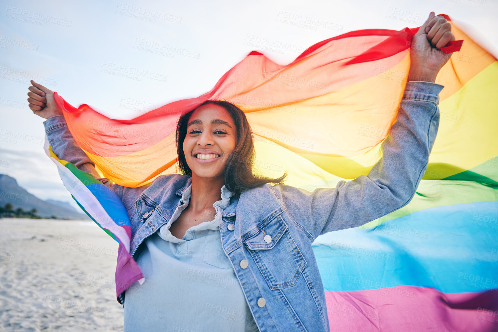 Buy stock photo Woman, beach and rainbow flag for lgbtq in portrait, smile and wind with wave, pride and equality for inclusion. Student girl, fabric or cloth for human rights, lesbian sexuality or happy on vacation