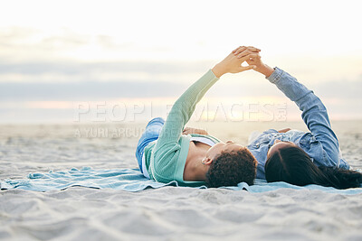 Buy stock photo Love, beach and lesbian couple on blanket together, holding hands on sand and sunset holiday adventure. Lgbt women, bonding and relax on ocean vacation with romance, pride and happy lying in nature.
