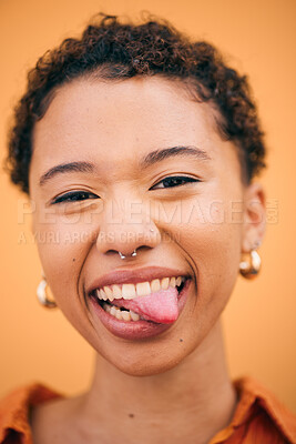Buy stock photo Happy, woman and tongue out portrait in studio with smile and confidence feeling silly. Orange background, young and African female person with trendy, modern and student fashion with gen z piercing