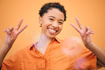 Buy stock photo Peace, hands and happy woman in studio with thank you, gesture and self love against orange background space. freedom, face and female model with v emoji sign for good mood, confidence or positivity