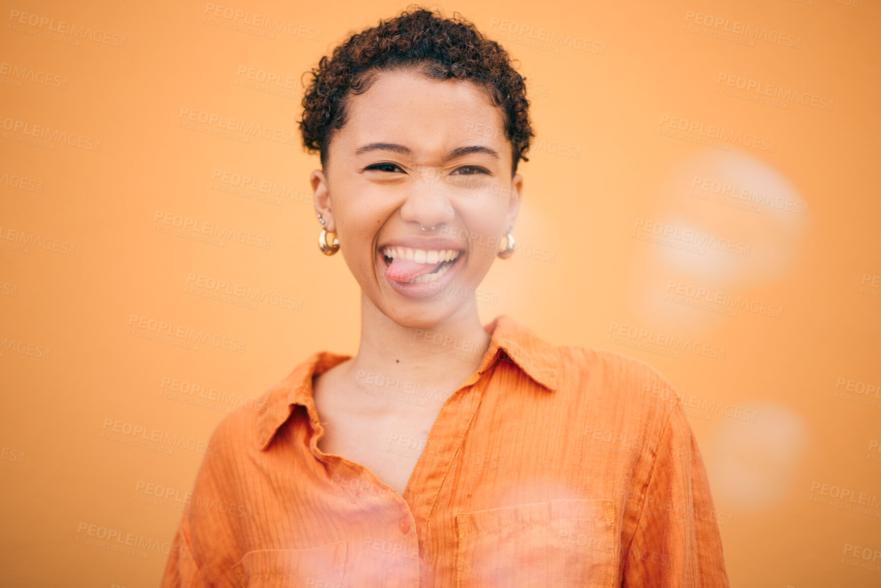 Buy stock photo Portrait, crazy and woman with tongue out in studio for funny, joke or expression against orange background space. Face, emoji and silly young female model pose with good mood, personality and humor