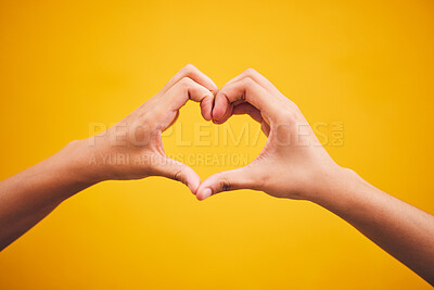 Buy stock photo Heart, hands and person in studio with thank you, message or gesture on orange background space. Emoji, frame and human fingers with self love, gratitude and kindness, empathy and hope of healing