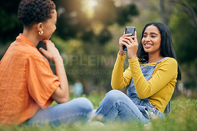 Buy stock photo Phone, photography and women at a park relax, bond and having fun on the weekend together. Profile picture, smartphone and female friends in forest with photo, memory and social media post in nature