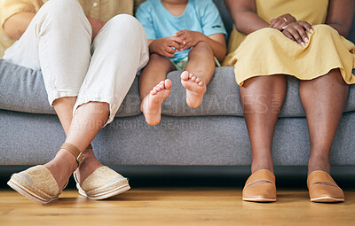 Buy stock photo Legs, gay couple and a family on a home sofa for security, quality time and love. Feet of women or lesbian parents and a young child together in a living room with trust, care or support for adoption
