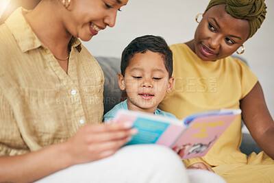 Buy stock photo Reading, gay family and child with a book on a home sofa for knowledge, education and learning. Adoption, lesbian or LGBT women or parents and kid together in a lounge with a story for quality time