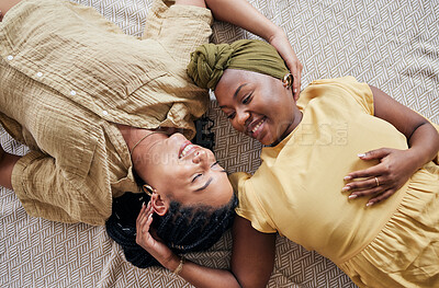 Buy stock photo LGBT, love and couple relax, happiness and smile for home bonding, support and enjoy quality time together. Romance, top view floor and gay people, queer partner or lesbian women connect in apartment