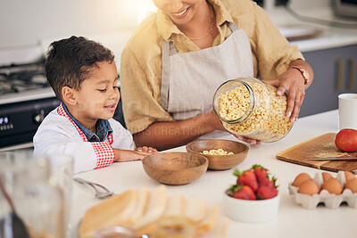 Buy stock photo Breakfast, smile and food help with family and cooking with morning cereal at a home. Kitchen, love and happy support of a mother and young child with teaching and care for baking learning together