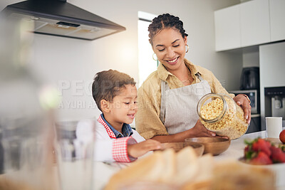 Buy stock photo Breakfast, smile and a mother and child cooking, baking or helping with food in the kitchen. House, eating and a boy kid and a young mom teaching during lunch or for dinner together while hungry
