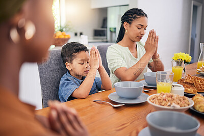 Praying, breakfast and morning with family at table for food, worship or religion. Prayer, gratitude and grace with parents and child in dining room at home for Christian, spiritual or faith together