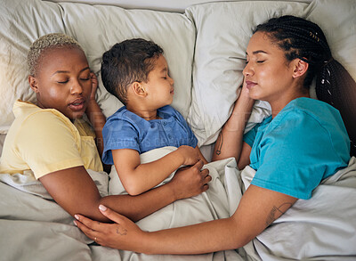 Buy stock photo Sleeping, gay family and relax in bed from above, hug and resting in their home together. Lgbt, sleep and lesbian couple with foster boy child in bedroom dreaming, care and adoption, comfort and love