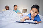 Children, tablet and education with a family in bed in the morning to relax together at home. Kids, technology and child development with a little boy in the bedroom to play a fun online game