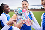 Sports women group, grass and bottle in circle for toast, celebration and diversity with team building, Girl friends, cheers and success with winning, goal and outdoor for training, wellness or water
