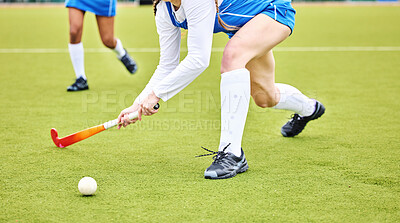 Buy stock photo Hockey, closeup and female athlete playing a game, match or tournament on an outdoor field. Fitness, sports and young woman training or practicing a defence strategy with a stick and ball at stadium.